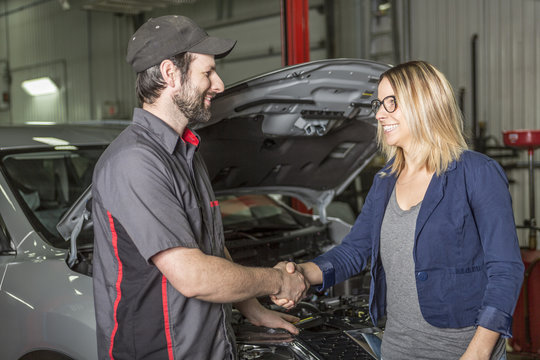 Auto Mechanic And Female Customer In Garage