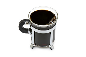 Close up of a mug in glass with dark black coffee