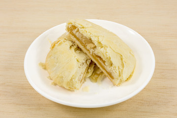 The Taiwanese sun cake (milk butter pastry) on the small white dish.