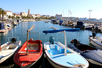 Fototapeta na wymiar Small fishing boats in Matejuska cove in Split, Croatia. Riva promenade with Saint Domnius bell tower in the background. 