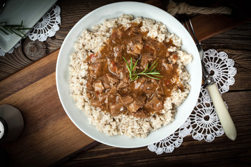 Cooked barley porridge and stew of pork.