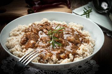 Cooked barley porridge and stew of pork.