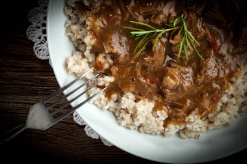 Cooked barley porridge and stew of pork.