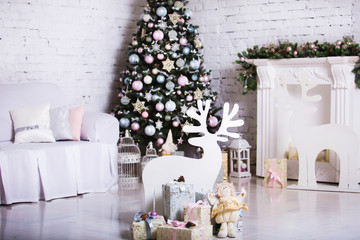 Interior room decorated in Christmas style. No people. Home comfort of modern house. Xmas tree and fireplace