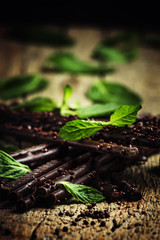 Dark chocolate with mint, vintage wood background, selective foc