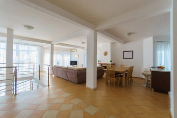 Interior of a living room with kitchen zone in a villa