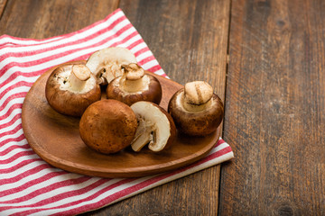 Mushrooms on a rustic wooden table. Copyspace.