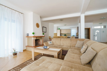 Interior of a living room with kitchen zone in a villa