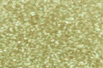 defocused abstract gold hearts light background