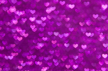 defocused abstract purple hearts light background