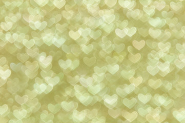 defocused abstract gold hearts light background