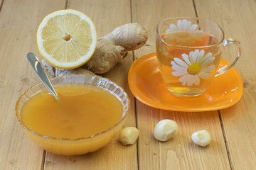 The root of ginger and honey on wooden table.