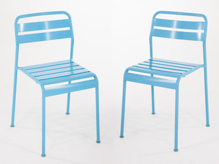Turquoise metal chairs on white