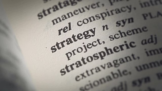 Detail footage of the word Strategy printed in a book
