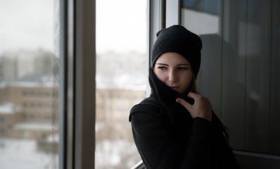 Girl looking through window