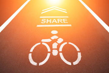 Sign on the cycling way meaning please share bike lanes for bikers.bicycles sign in the park with sunset light.