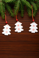 Figure Christmas trees hanging on spruce branch