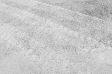 Closeup surface concrete floor with tire tracks textured background in black and white tone