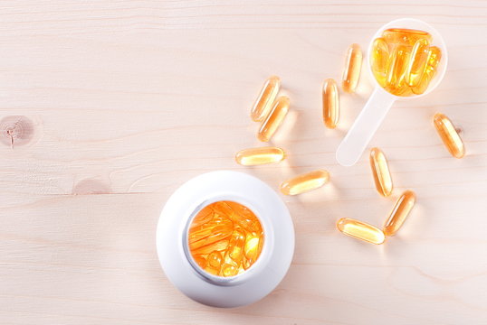 fish oil capsules in a jar on a table