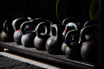 Dumbbell for weight training in gym. Black kettlebells.