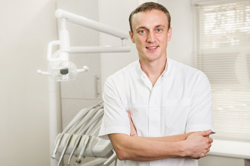 Fototapeta premium attractive dentist in white uniform