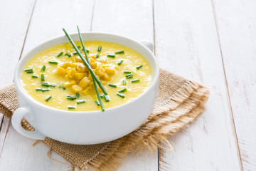 Corn soup in white bowl on white wooden background.copyspace
