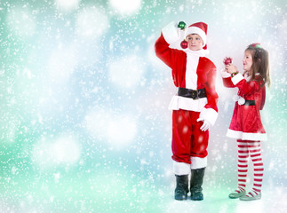 boy and girl as santa and elf