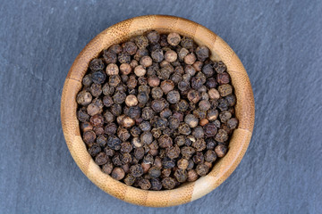 Bamboo bowl with black pepper
