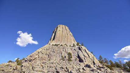 Panoramic picture of the Devils Tower, a laccolith butte composed of igneous rock in the Bear Lodge Mountains, National Monument in Wyoming, USA.