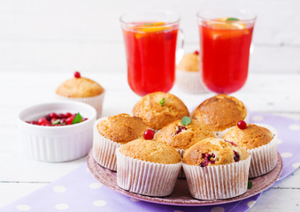 Tasty muffin (cupcake) with cranberries and cranberry-orange drink.