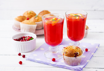 Tasty muffin (cupcake) with cranberries and cranberry-orange drink.