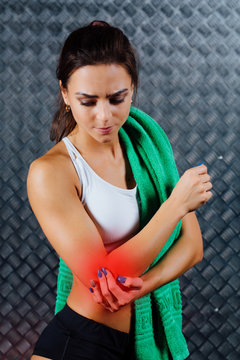 Beautiful young fitness woman feeling pain.