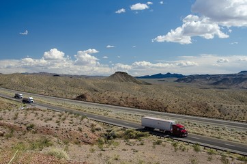 Trucks moving on a highway in the desert of Nevada