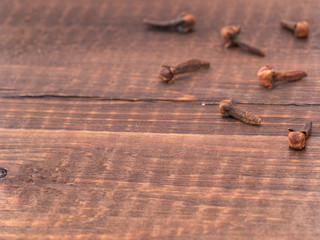 Cloves spice on wooden background