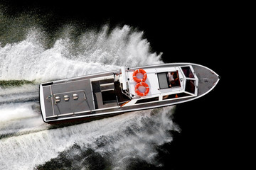 Black and white speed boat speeding on the sea