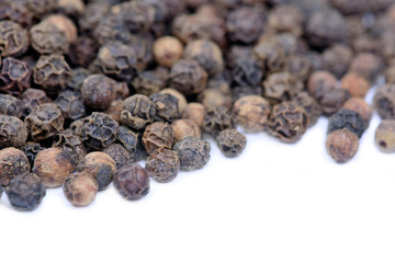 Black pepper on white background