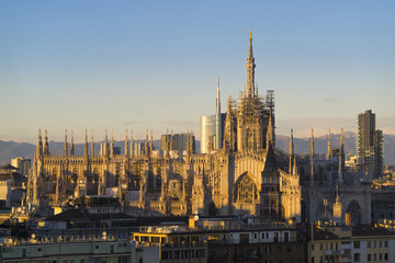 Duomo di Milano with Milan Skyline and alps on background at daw