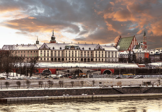View of the Royal Castle and the Vistula river in the Old Town of Warsaw at winter sunset, Poland