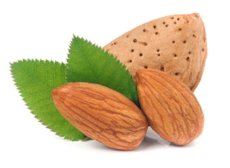 almonds in their skins and peeled with leaf isolated on white background