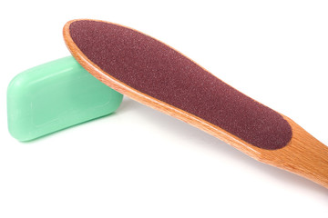 wooden double-sided grater for feet with soap isolated on white background