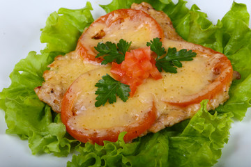 Pork baked with tomato and cheese