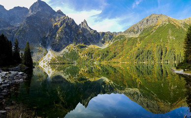 Crystal clear lake in high mountains - wide panorama of morskie Oko - lake in Tatra Mountains