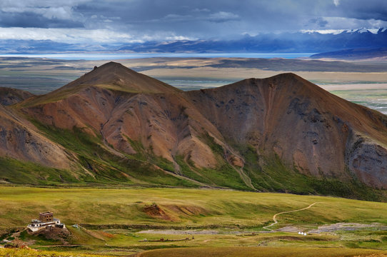 Buddhist monastery against a mountain ridge and lake Manasarowar.