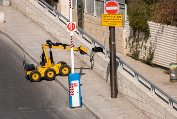 Bomb Disposal Army or Police Robot shoot and chek the bag close to Western Wall at Jerusalem. Israel