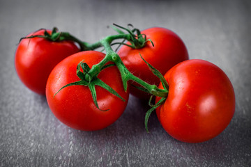 Fresh tomatoes  on a rustic  background