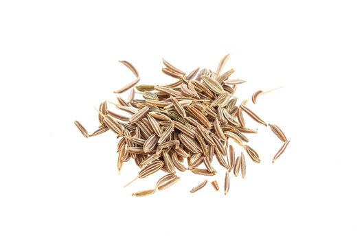 Close up pile of Cumin seeds isolated on white background