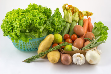 Fresh vegetables mix isolated on white / colorful fresh vegetable with leaves isolated on white background / fresh vegetables with leaves in the basket isolated on white background .