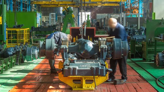 Conveyor assembly stage the body of tractor at factory timelapse