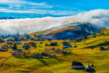 Rural landscape with fog in Sirnea – Fundata village, Transylvania landmark, Romania