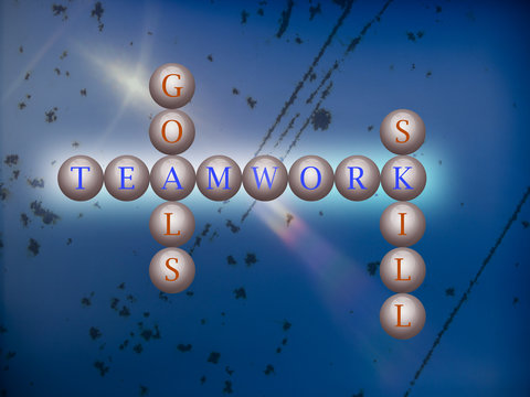 Teamwork word cloud writen on balls infront of a wall background